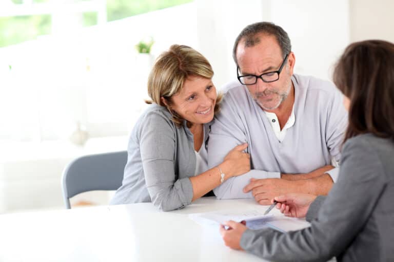 Senior couple signing financial contract